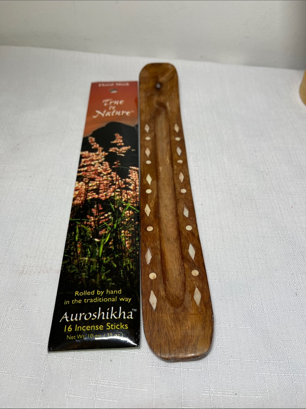 True to nature, floral musk, incense, sticks, and wood tray.
